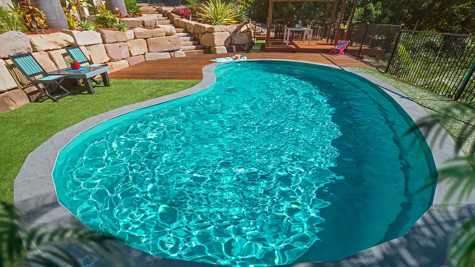 Aquamarine_Hero A Leisure Pools backyard pool in Aquamarine color